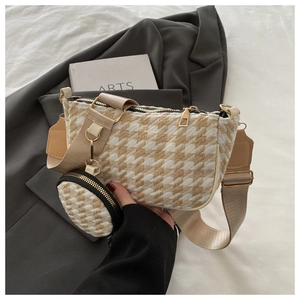 Close-up of houndstooth crossbody bag with wide strap and matching mini coin purse