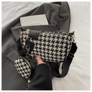 Detail of houndstooth crossbody bag with mini round coin purse and wide adjustable strap