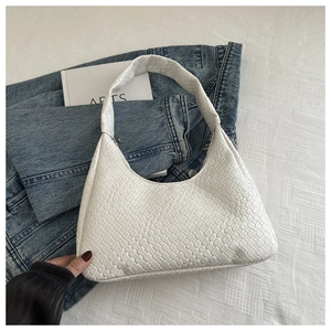 Détail du sac hobo blanc en similicuir tressé avec texture quadrillée sur fond minimaliste