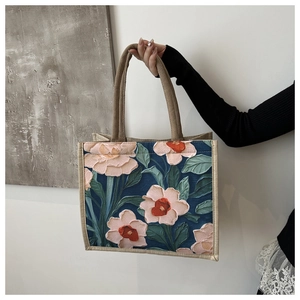 Detail of oil painting floral print on linen tote bag with woven edges and sturdy handle
