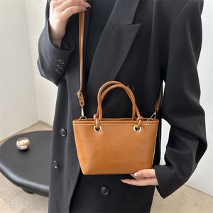 Brown retro PU leather crossbody bucket bag with top handle and adjustable strap