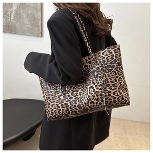 Leopard print tote bag styled with a black blazer on a model for a modern commute look
