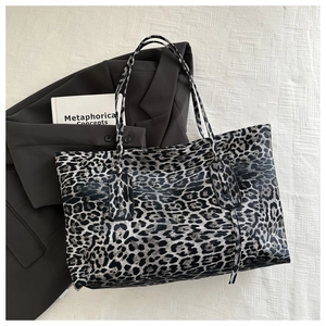 Detail of large leopard print tote bag with fine texture and slim shoulder straps