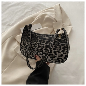 Detail of leopard print hobo bag showing faux leather texture and metallic zipper closure