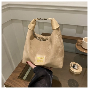 Detailed close-up of a beige crescent hobo bag with top metal handle and branded logo patch