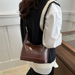 Retro minimalist dark brown crescent shoulder bag in glossy leather with embossed text