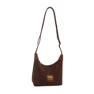 Brown nylon hobo shoulder bag with adjustable strap and front leather logo patch