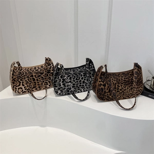 Three leopard print hobo shoulder bags in beige, grey, and coffee on white steps