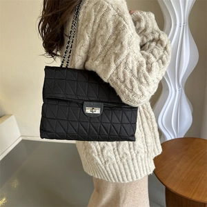 Large capacity black quilted shoulder bag with chain strap and metal twist lock