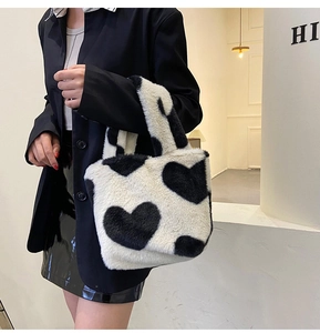 Dettaglio della borsa tote in peluche a cuori bianchi e neri per look invernale