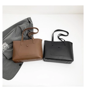 Flat lay of minimalist coffee brown and black tote bags with front pockets and dual handles