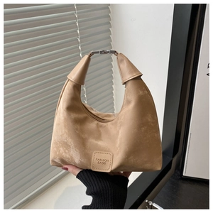 Detail of khaki suede hobo bag featuring folded handle and Fashion Bags embossed logo