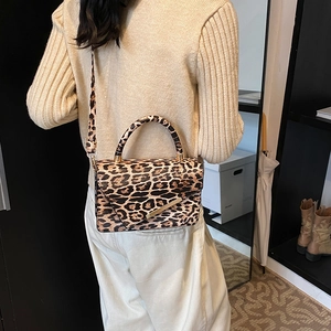 Chic leopard print crossbody bag with gold metal trim and adjustable strap for women