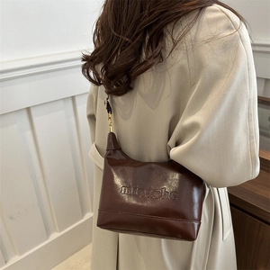 Brown leather tote bag with embossed mioashe logo and golden metal buckle for women