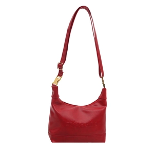 Minimalist red faux leather crescent tote bag with adjustable shoulder strap and gold hardware