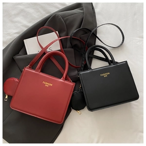 Close-up of sleek PU leather square handbags in red and black with round coin purses