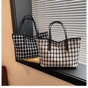 Detailed view of tweed plaid tote bags with leather handles in a sunlit window setting