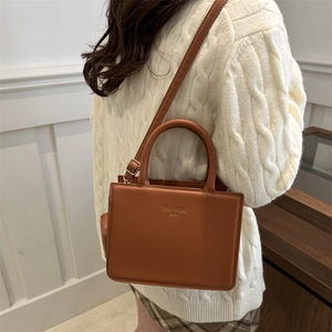 Minimalist brown rectangular faux leather shoulder bag with a fashion bag gold logo