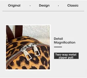 Detail view of smooth metal dual zippers on leopard print faux suede backpack