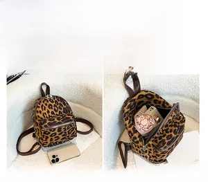 Internal capacity view of leopard print faux suede backpack showing daily essentials