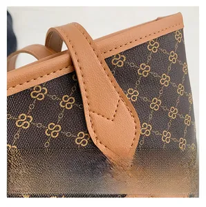 Close-up of precise stitching on the leather handle and vintage patterned tote bag