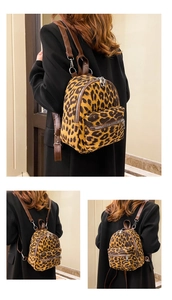 Detail of leopard print suede mini backpack featuring silver zippers and leather straps