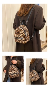 Detailed close-up of a leopard print faux suede mini backpack showing straps and textures