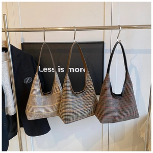 Detailed macro shot of vintage plaid woolen tote bags in three distinct color patterns