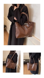 Macro detail of the brown leather tote bag with side metal zipper and fine texture