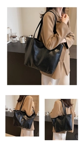 Close-up of a black oversized tote bag with premium leather texture and soft finish