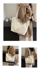 Detailed close-up of cream large tote bag showing textured PU leather and long shoulder strap
