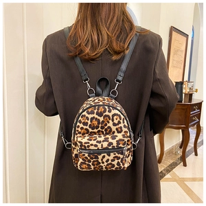 Close-up of stylish leopard print mini backpack in faux suede with adjustable leather straps
