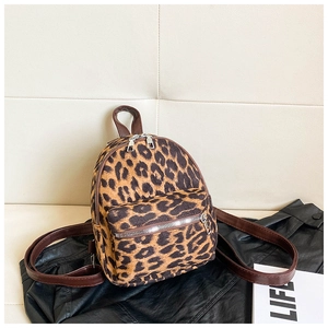 Detailed close-up of leopard print suede mini backpack with brown straps and silver zippers