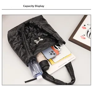 Top view of spacious black quilted tote showing storage for iPad, umbrella, and essentials