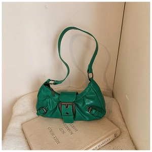 Close-up of retro green moon bag with textured leather and vintage bronze buckle