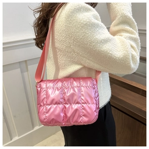 Close-up of pink quilted puffer bag with metallic finish and wide shoulder strap