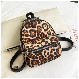 Close-up of leopard print faux fur backpack texture and silver zipper detail