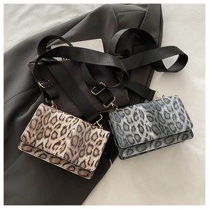 Detail of leopard print crossbody bag with wide strap and adjustable gold metal buckle