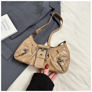 Detail showing the light khaki pleated PU leather bag with vintage metal buckles