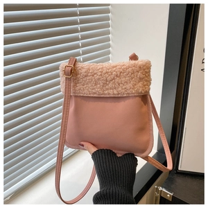 Detail view of pink plush fleece patchwork crossbody bag with textured matte finish