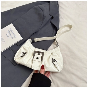 Detail of white PU leather underarm bag with pleated design and bronze buckle