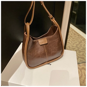 Close-up of the vintage brown tote featuring a Fashion embossed leather label detail