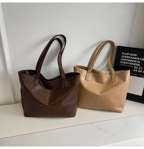 Detail of premium PU leather tote bags in dark brown and beige with fine grain texture