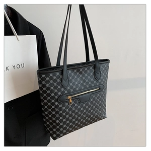 Detail view of large shoulder tote with geometric patterns and gold zipper pocket