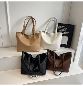 Detailed close-up of large capacity leather tote bags in khaki, white, black and brown