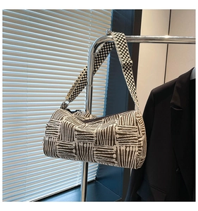 Close-up of a modern checkered nylon tote bag featuring a wide stylish shoulder strap