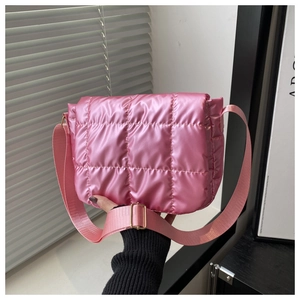 Close-up of pink quilted puffer bag with square stitching and gold metal buckle
