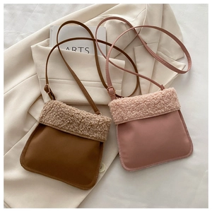 Detail of plush faux shearling patchwork crossbody bags in brown and pink colors