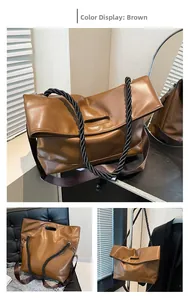Brown large tote bag with twisted black handles and wide shoulder strap details