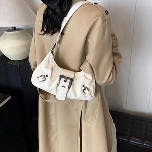 Minimalist white pleated half-moon shoulder bag with retro metal buckles on strap